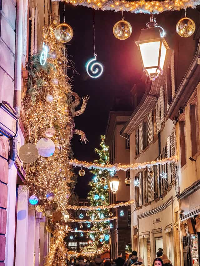 Christmas lights and decorations adorn a street in Strasbourg, France.