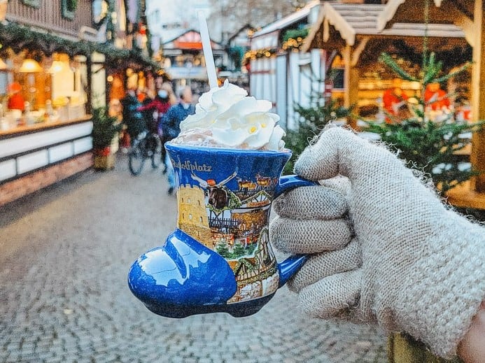 the blue boot mugs filled with hot chocolate and topped with whipped cream in the Cologne Christmas market. 