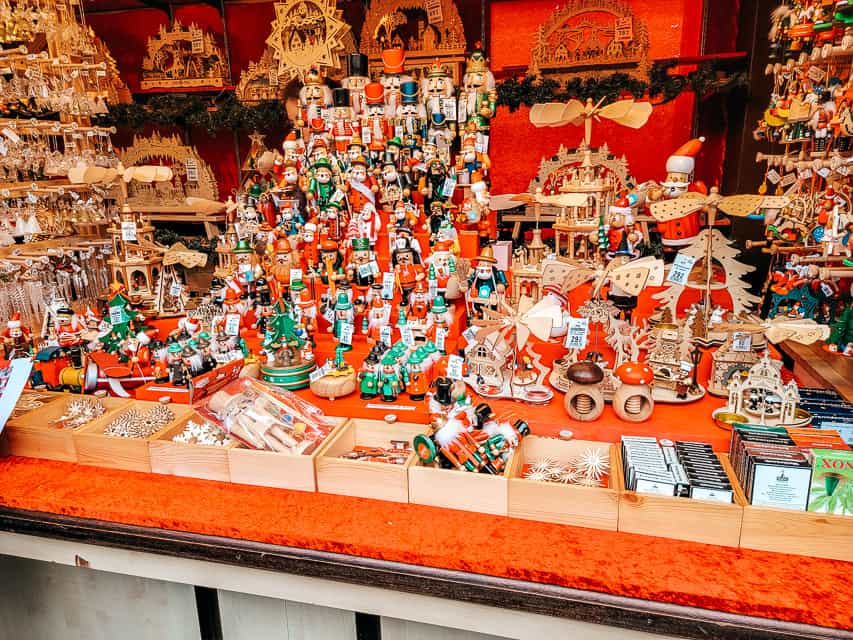A red stall full of nutcrackers, tin soldiers, and other Christmas decor at the market. 