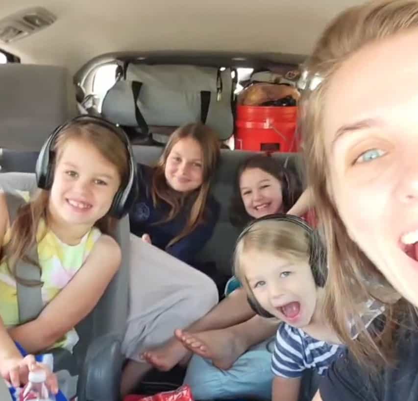 A selfie of a mom and four daughters in a packed car.