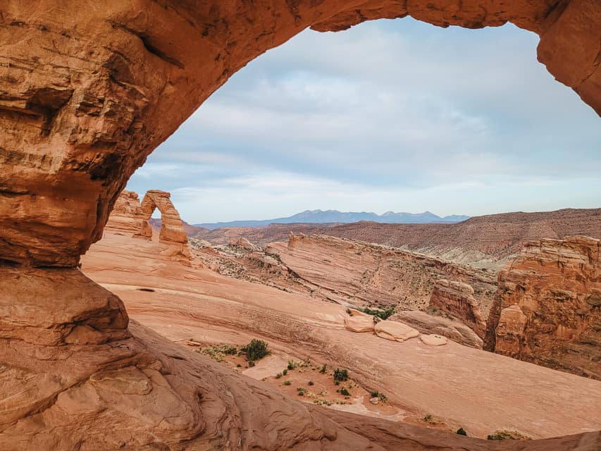 Delicate Arch is seen framed through Twisted Donut Arch.