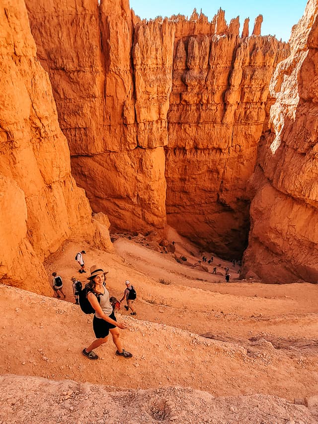 A woman looks up as she walks down tight switchbacks in Wall Street in Bryce Canyon.