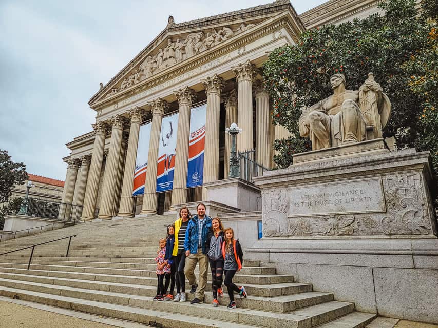 A family stands on the steps of the National Archives. Seeing the Declaration and Constitution is a fantastic reason to visit DC.