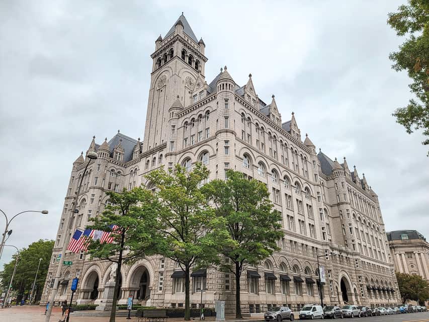 The Old Post Office is a gray stone building that resembles a castle with a tall clock tower.