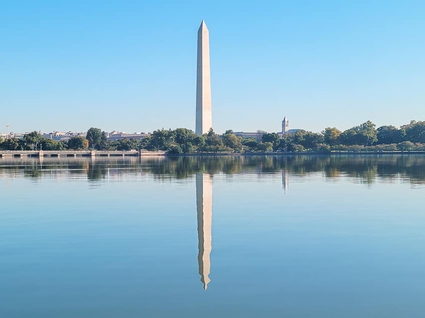 The Washington Monuments reflects in the water as seen from the Jefferson Memorial. The beautiful memorials are a major reason to visit Washington, D.C.