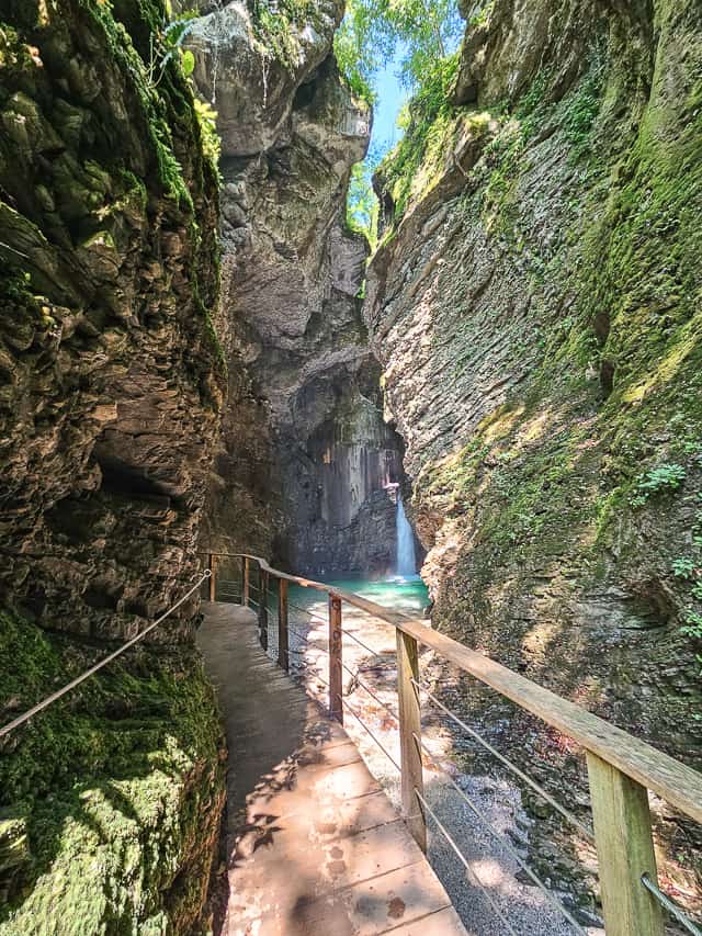 A wooden boardwalk continues around the rock wall where you can see the gorgeous Kozjak waterfall with its crystal clear turquoise water. 